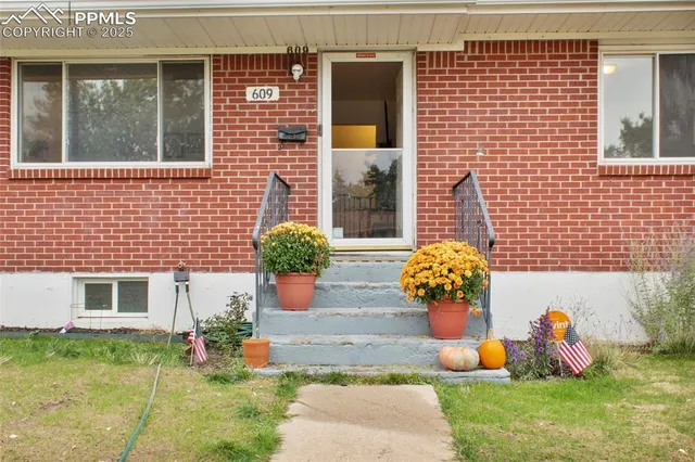 a front view of a house with outdoor seating space