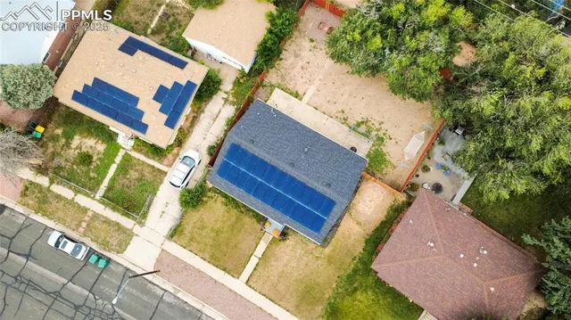 an aerial view of a house with a yard and potted plants