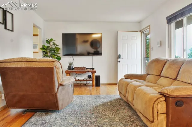 a living room with furniture and a flat screen tv