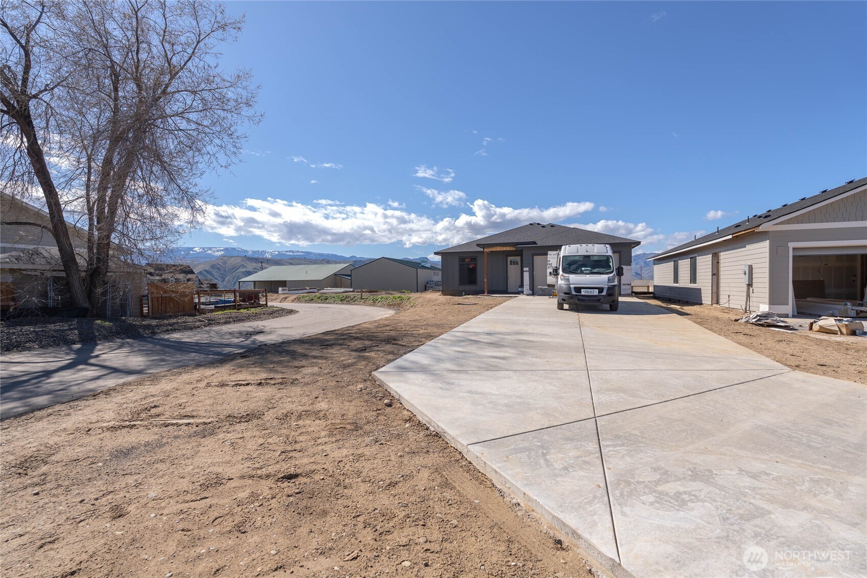 550 South Oasis Loop East Wenatchee, WA 98802 - Photo 36 of 36 a front view of a building with large trees