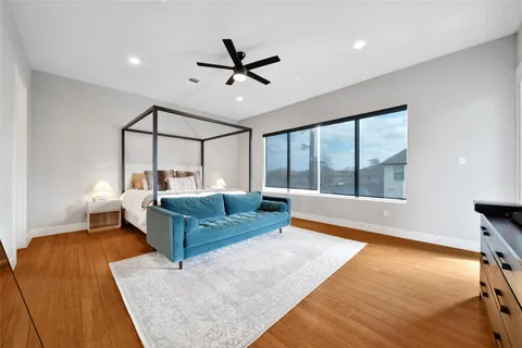 a bedroom with a bed and wooden floor