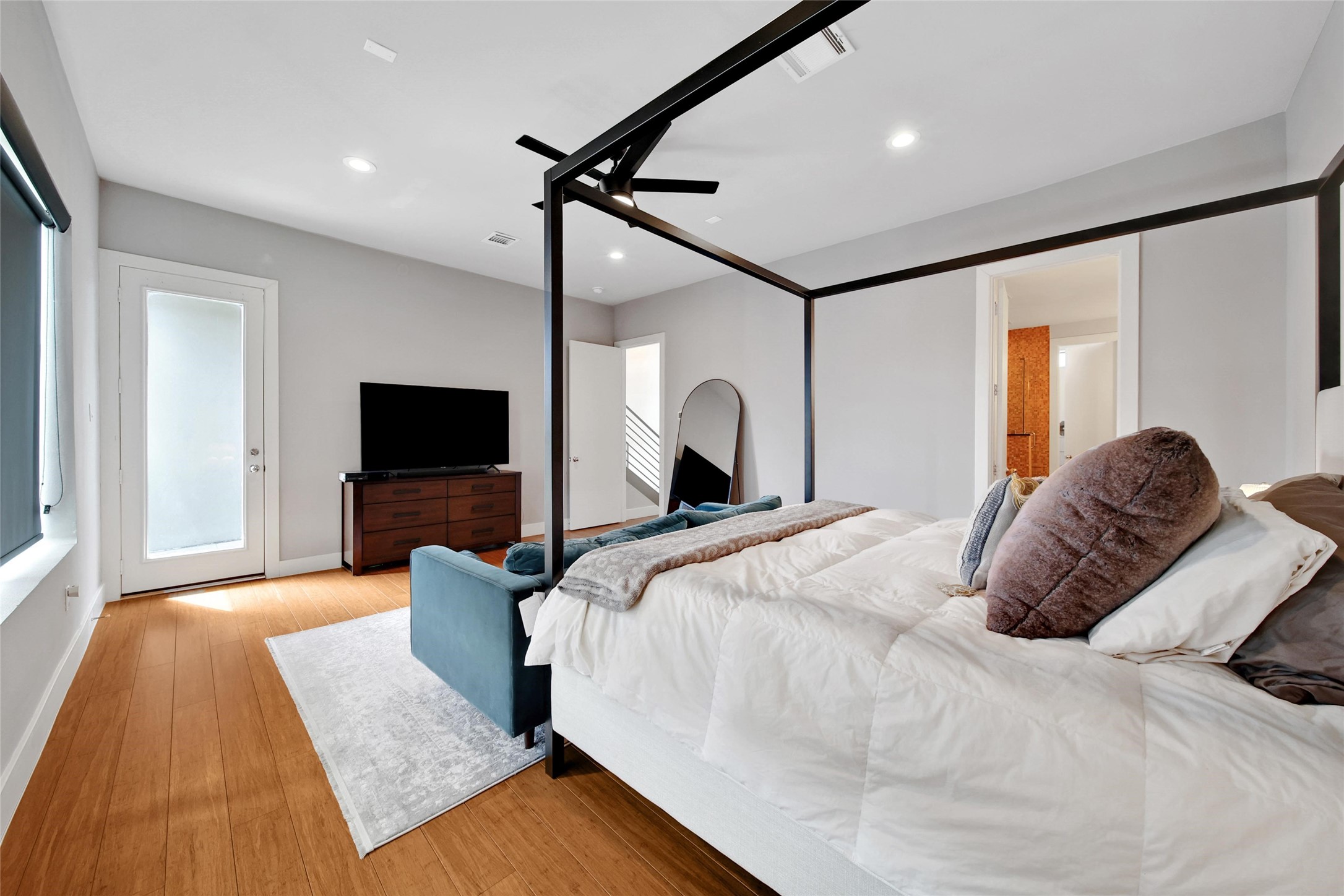 1407 Hickory Street Houston, TX 77007 - Photo 17 of 38 a bedroom with a bed and a flat screen tv