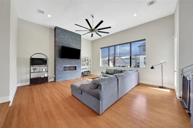 a living room with furniture a fireplace and a flat screen tv