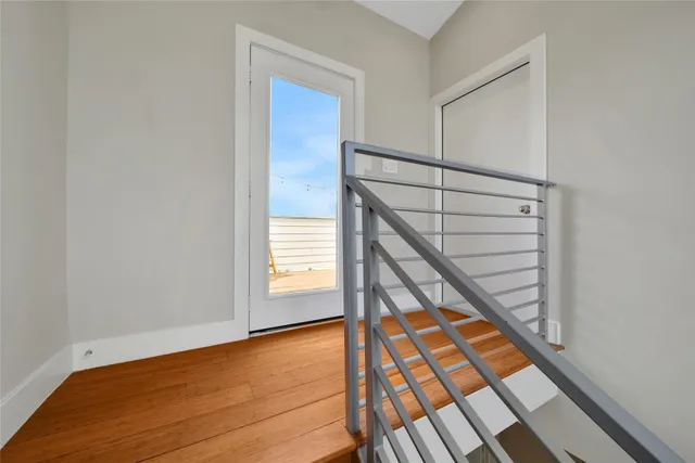 a view of a wooden chairs on roof deck