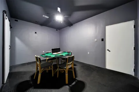 a view of the house with a yard and large parking space