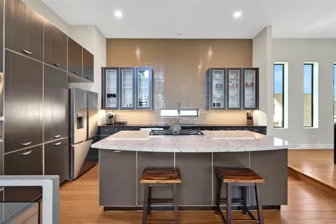 a kitchen with stainless steel appliances granite countertop a sink and a refrigerator