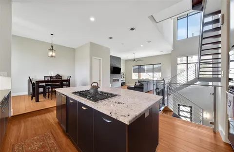 a large kitchen with kitchen island a sink stainless steel appliances and cabinets