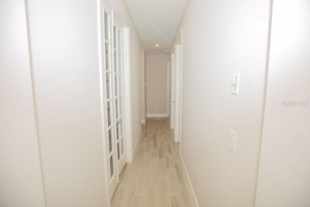 4605 Rosatti Road Wesley Chapel, FL 33543 - Photo 13 of 26 a view of a hallway with wooden floor