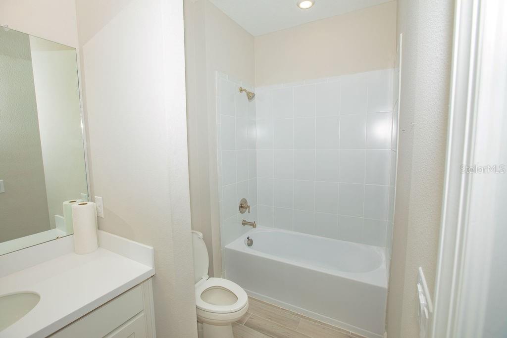 4605 Rosatti Road Wesley Chapel, FL 33543 - Photo 18 of 26 a bathroom with a sink a toilet and shower
