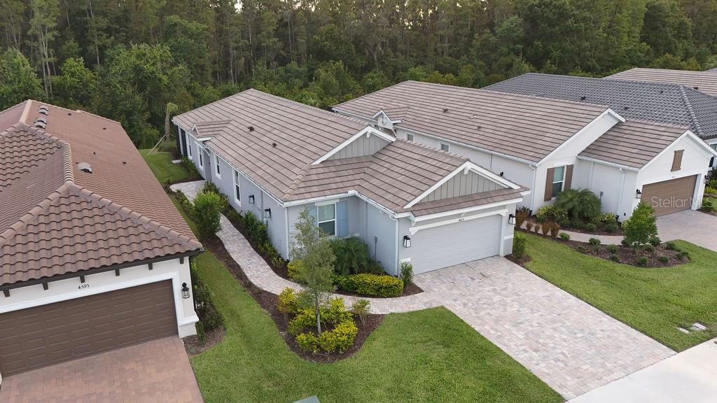 4605 Rosatti Road Wesley Chapel, FL 33543 - Photo 25 of 26 a aerial view of a house with a yard table and chairs