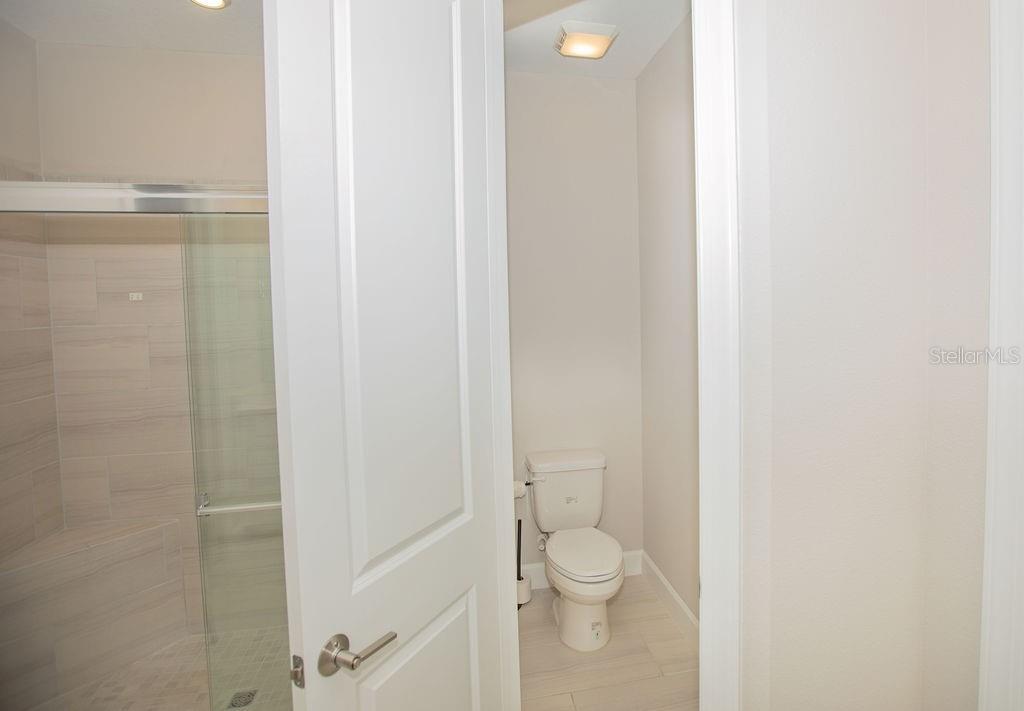 4605 Rosatti Road Wesley Chapel, FL 33543 - Photo 8 of 26 a bathroom with a toilet and a shower