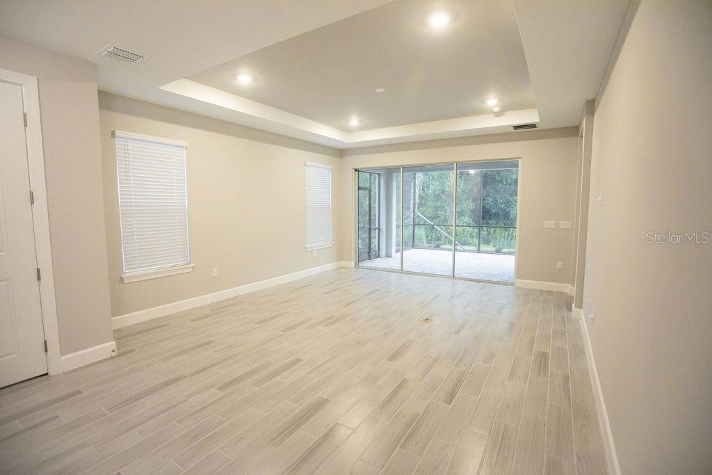 4605 Rosatti Road Wesley Chapel, FL 33543 - Photo 9 of 26 wooden floor in an empty room with a window