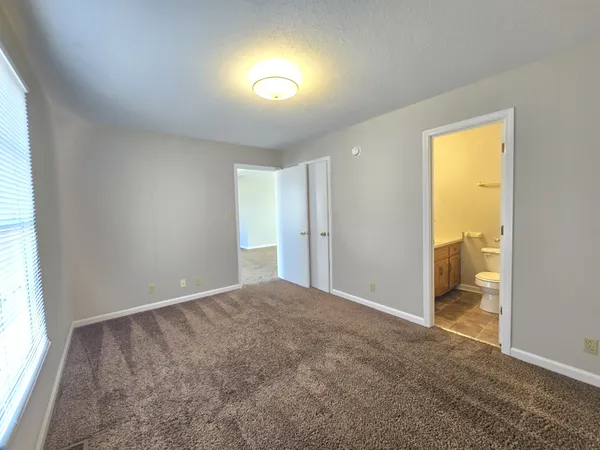 a view of an empty room and a window