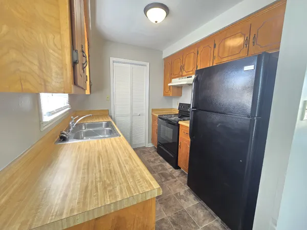 a kitchen with a refrigerator and a stove