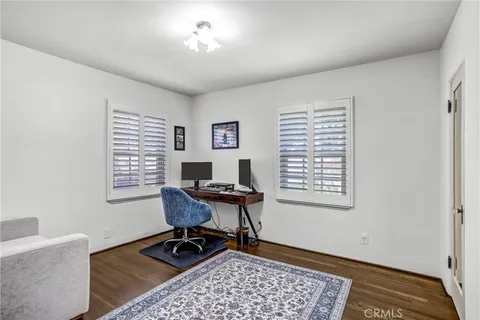 a bedroom with furniture and a flat screen tv