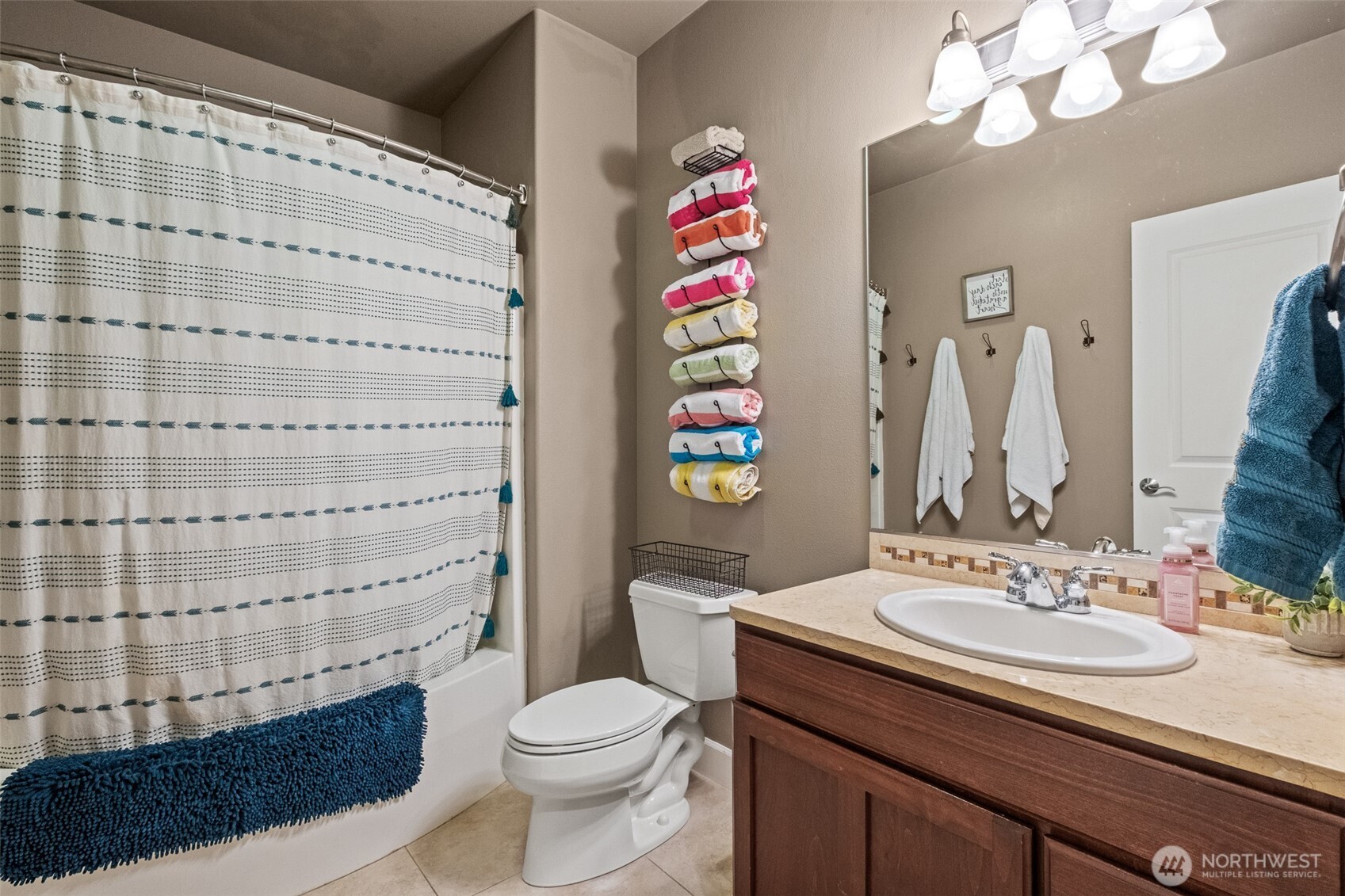 23325 Sunserra Loop, Unit A44 Quincy, WA 98848 - Photo 26 of 34 a bathroom with a sink a toilet and shower curtain