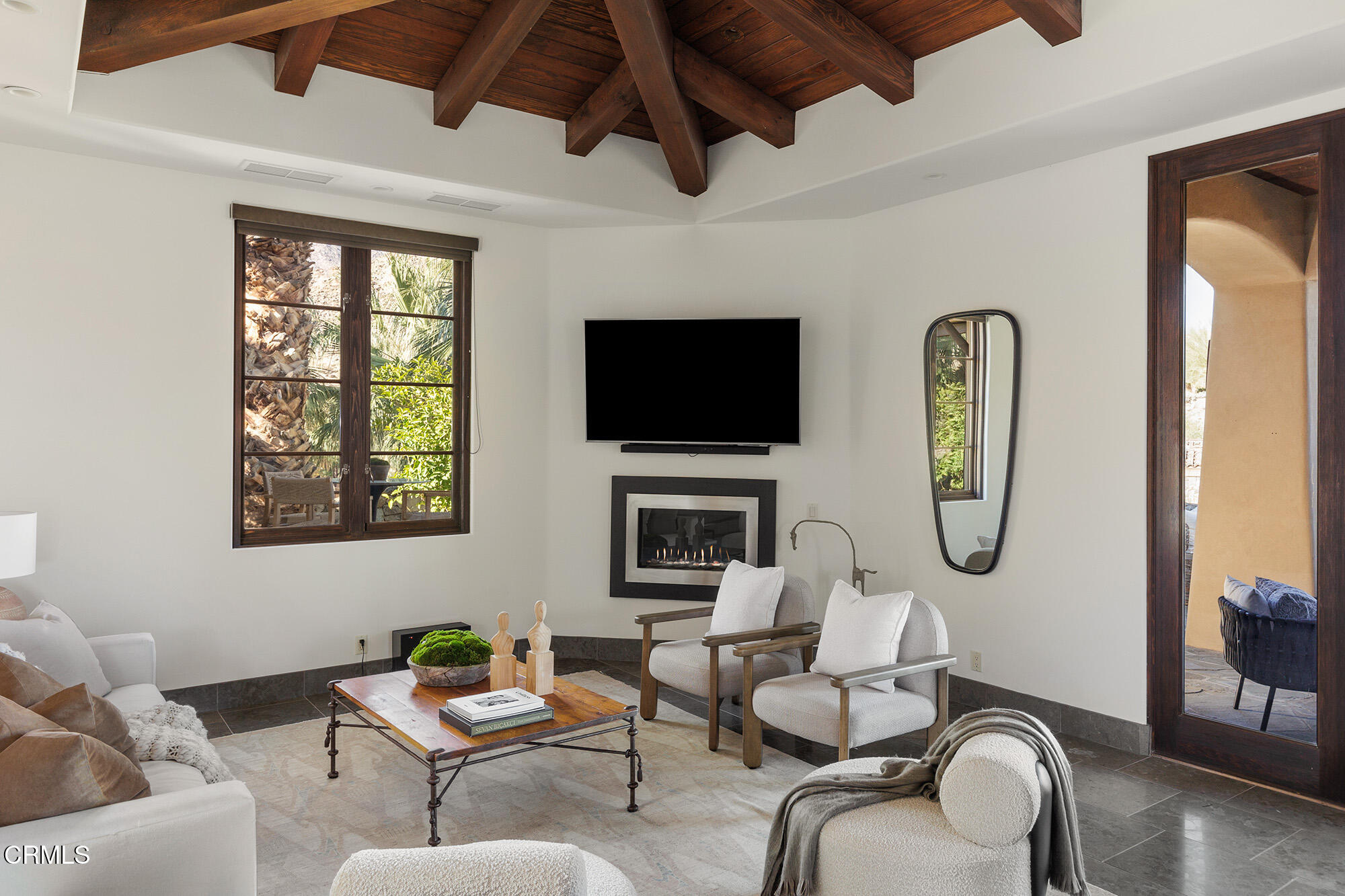 72265 Bajada Trail Palm Desert, CA 92260 - Photo 8 of 25 a living room with furniture a fireplace and a flat screen tv