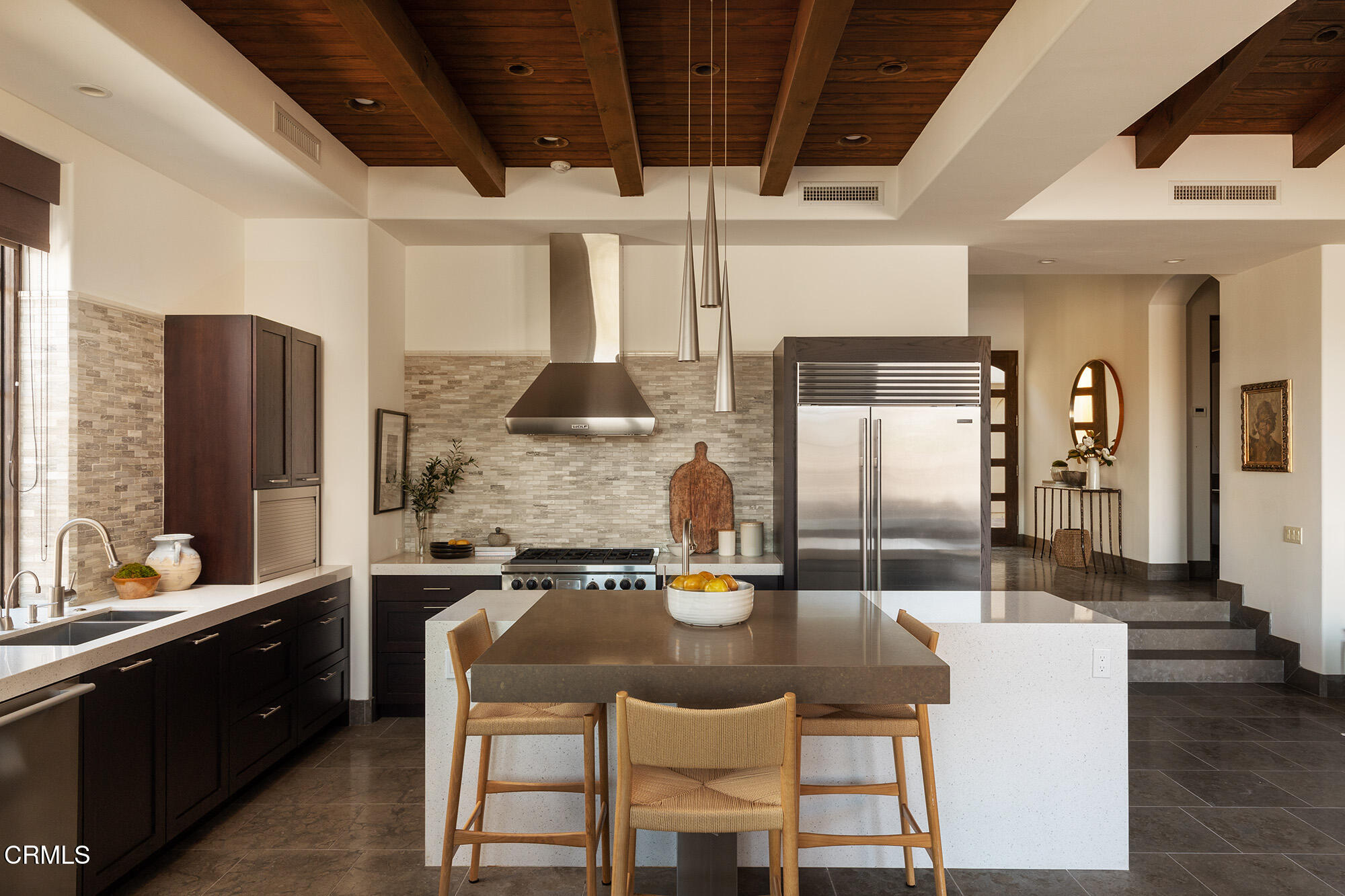 72265 Bajada Trail Palm Desert, CA 92260 - Photo 9 of 25 a kitchen with granite countertop a refrigerator a stove a sink and a dining table with wooden floor
