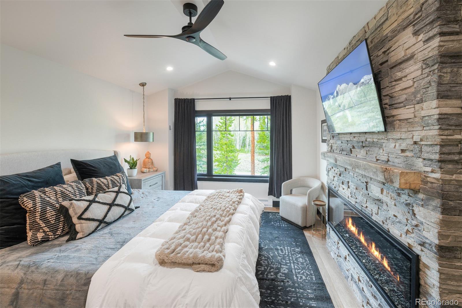 306 Golden Eagle Road Silverthorne, CO 80498 - Photo 19 of 43 a spacious bedroom with a bed and a couch