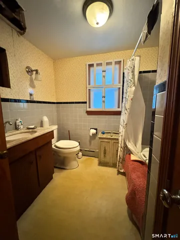 a bathroom with a sink mirror vanity and toilet