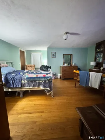 a bedroom with a bed and a view of kitchen