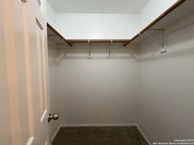 a bathroom with a granite countertop sink toilet and mirror