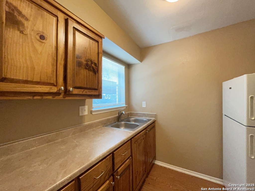 2802 Lasses Boulevard, Unit 42 San Antonio, TX 78223 - Photo 8 of 33 a bathroom with a sink and a mirror