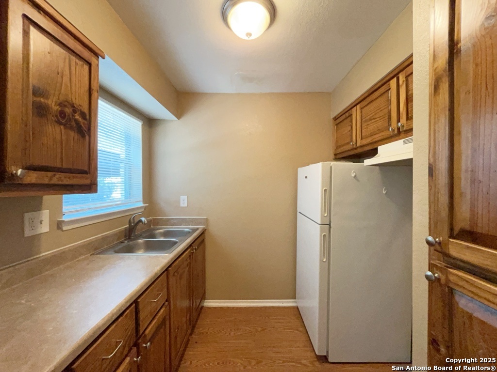 2802 Lasses Boulevard, Unit 42 San Antonio, TX 78223 - Photo 9 of 33 a kitchen with a refrigerator and a sink