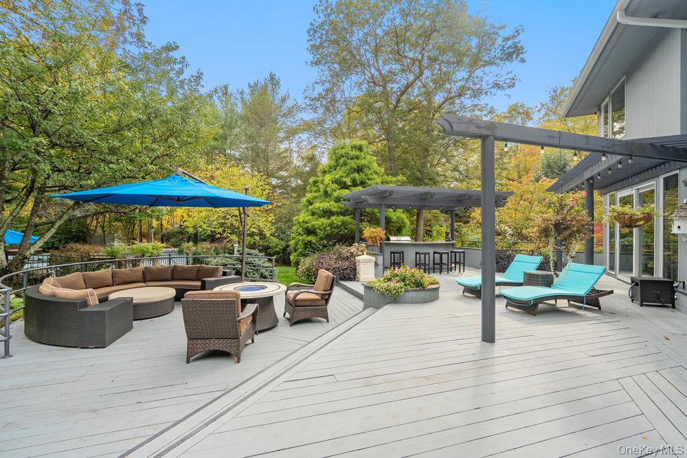 8 Forest Court Syosset, NY 11791 - Photo 27 of 40 View of oversized wood deck with outdoor cooking and seating