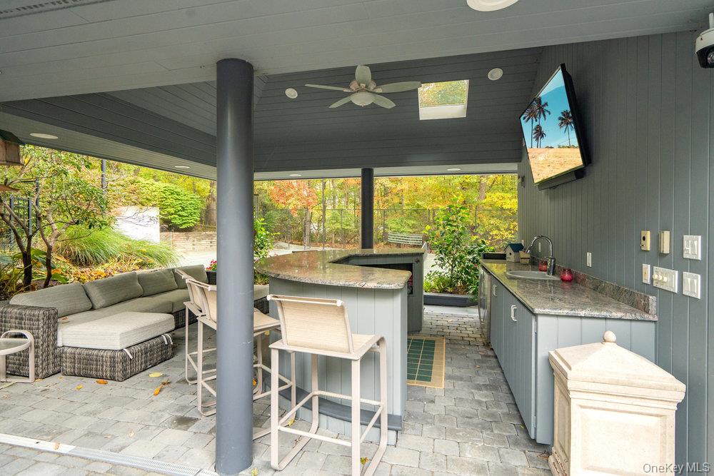 8 Forest Court Syosset, NY 11791 - Photo 32 of 40 View of outdoor cabana seating between pool and tennis court