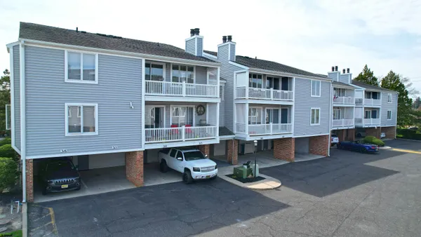 a front view of a building with a yard