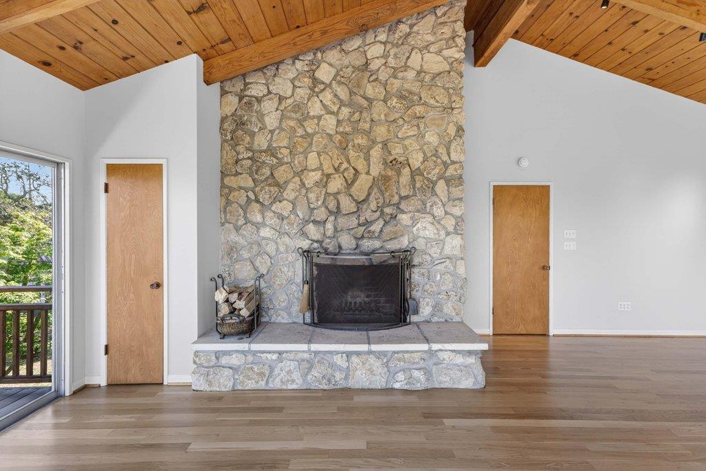 505 Hidden Valley Road Watsonville, CA 95076 - Photo 26 of 72 a living room with a fireplace and a wooden floor