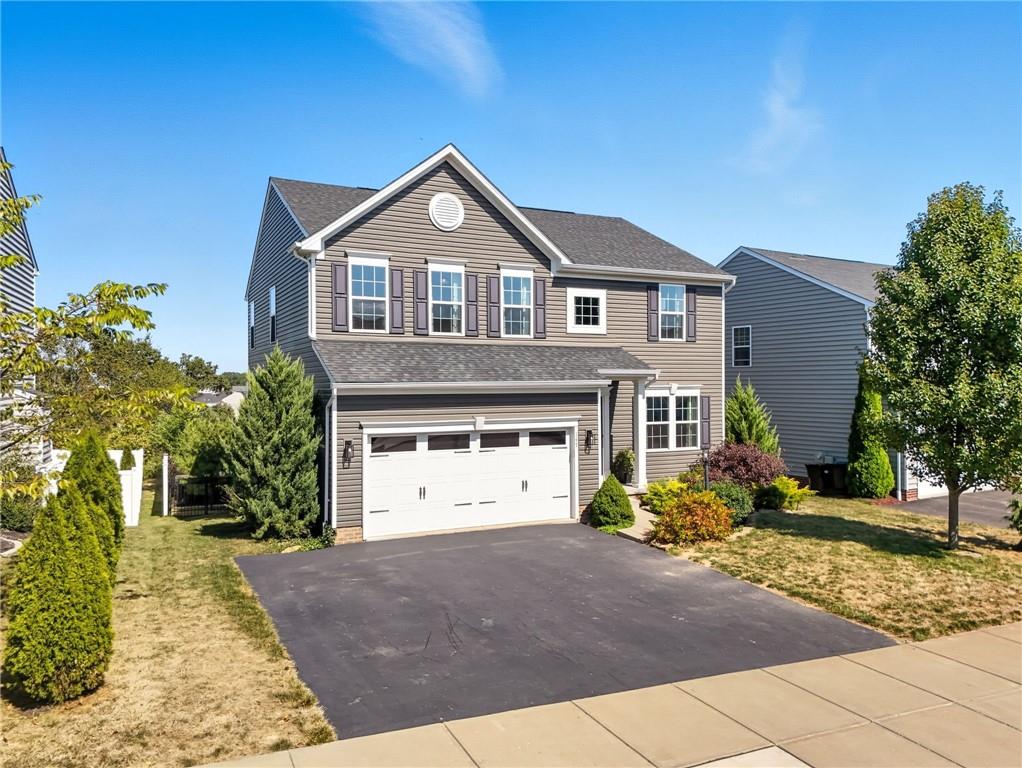 347 Ranchero Drive Coraopolis, PA 15108 - Photo 4 of 46 a front view of a house with a yard and garage