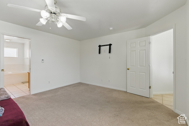 151 South Haulage Road Eureka, UT 84628 - Photo 16 of 36 Unfurnished bedroom with light colored carpet, light tile patterned floors, and a ceiling fan