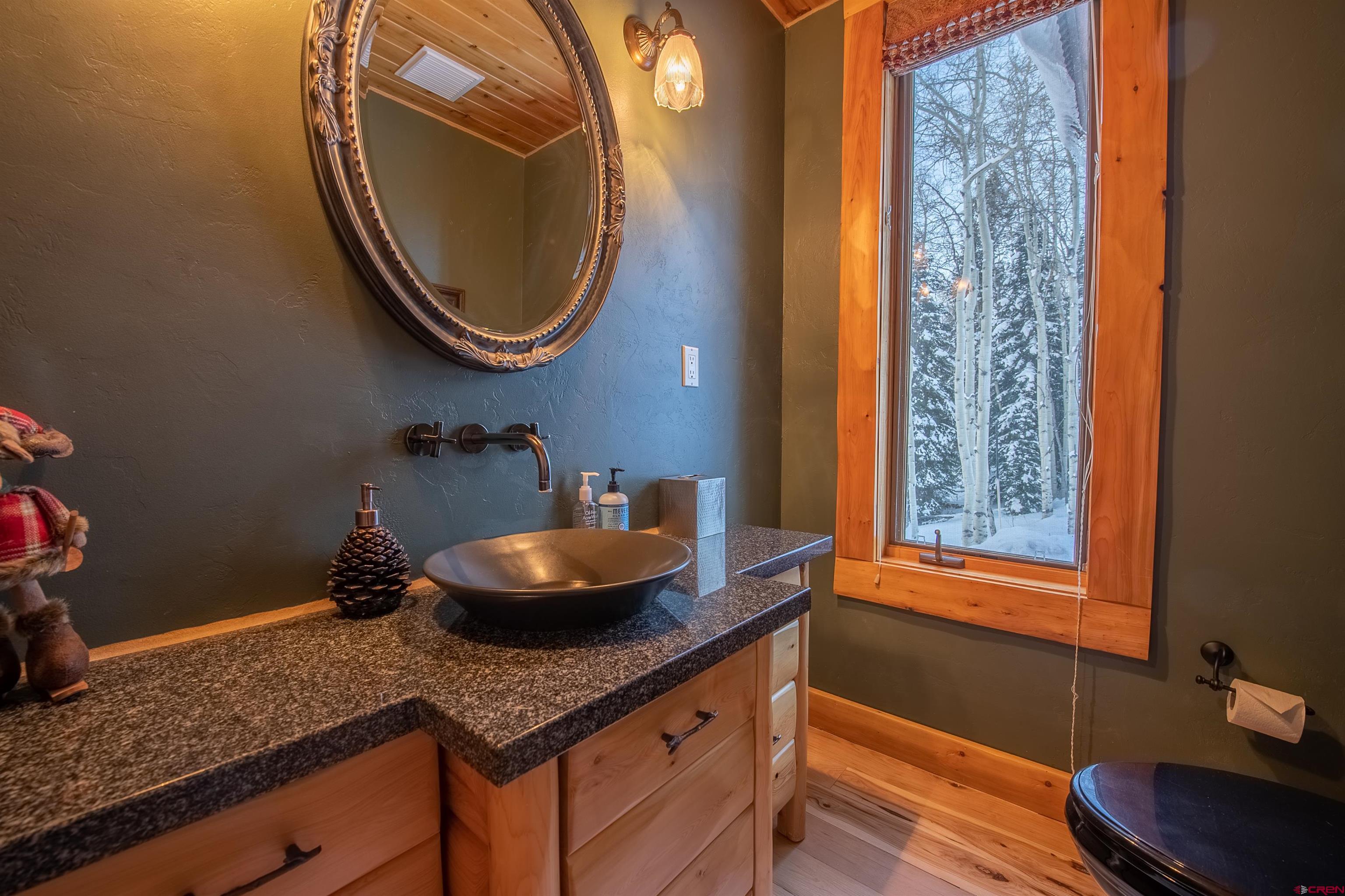 1894 Red Mountain Ranch Road Crested Butte, CO 81224 - Photo 11 of 34 a bathroom with a granite countertop sink and a mirror