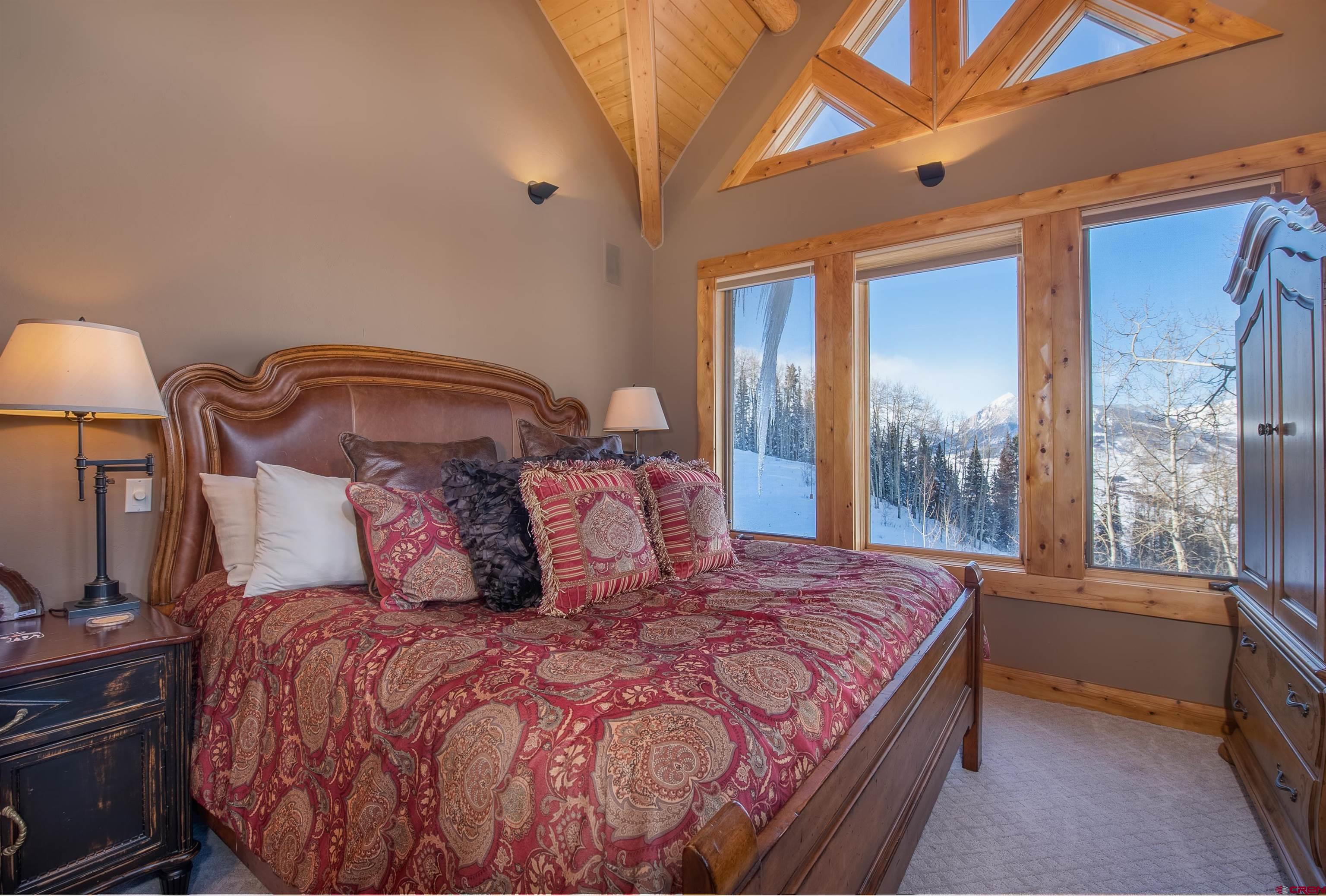 1894 Red Mountain Ranch Road Crested Butte, CO 81224 - Photo 17 of 34 a large bed sitting in a bedroom next to a window