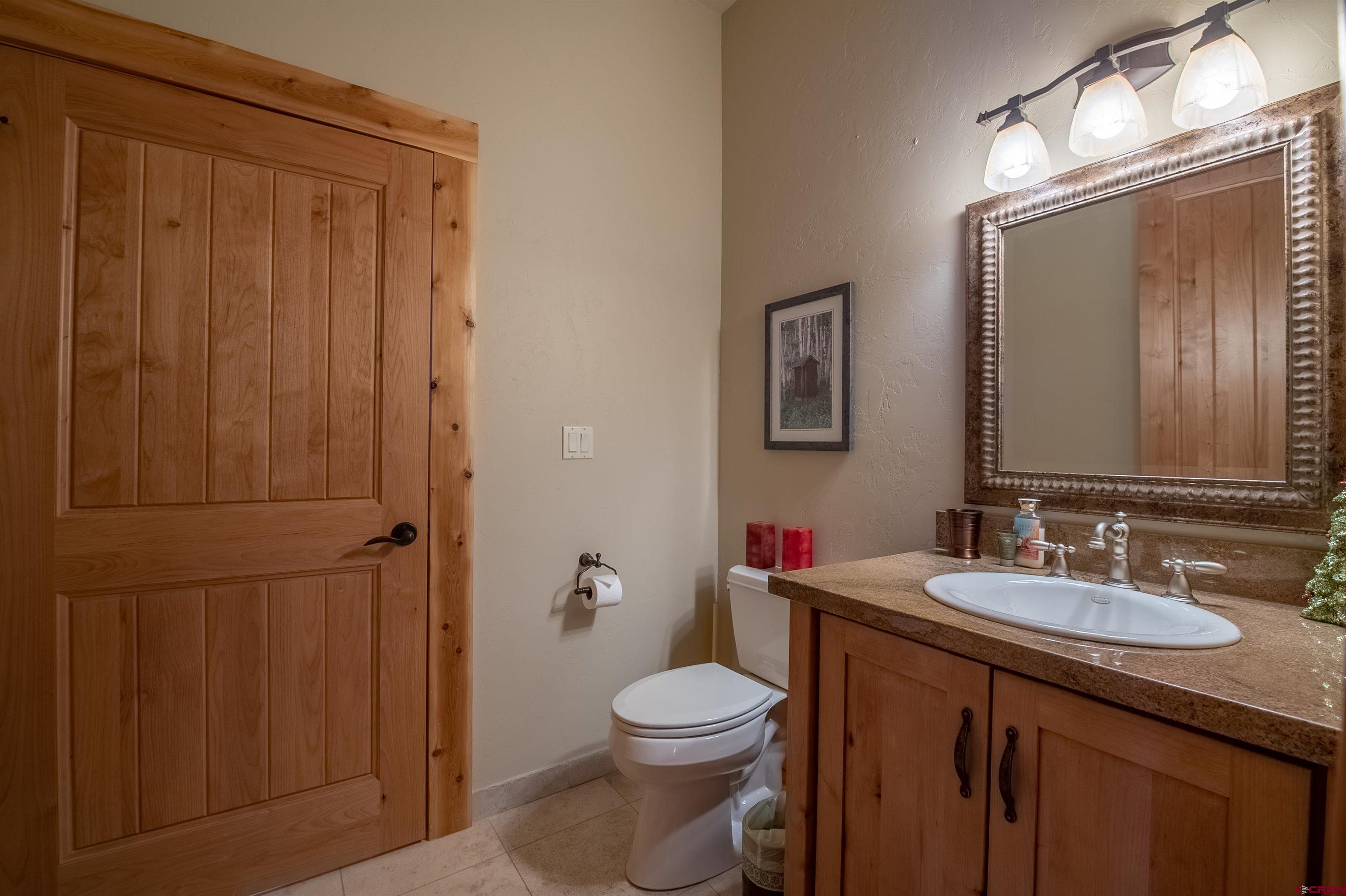 1894 Red Mountain Ranch Road Crested Butte, CO 81224 - Photo 20 of 34 a bathroom with a toilet a sink a vanity and mirror