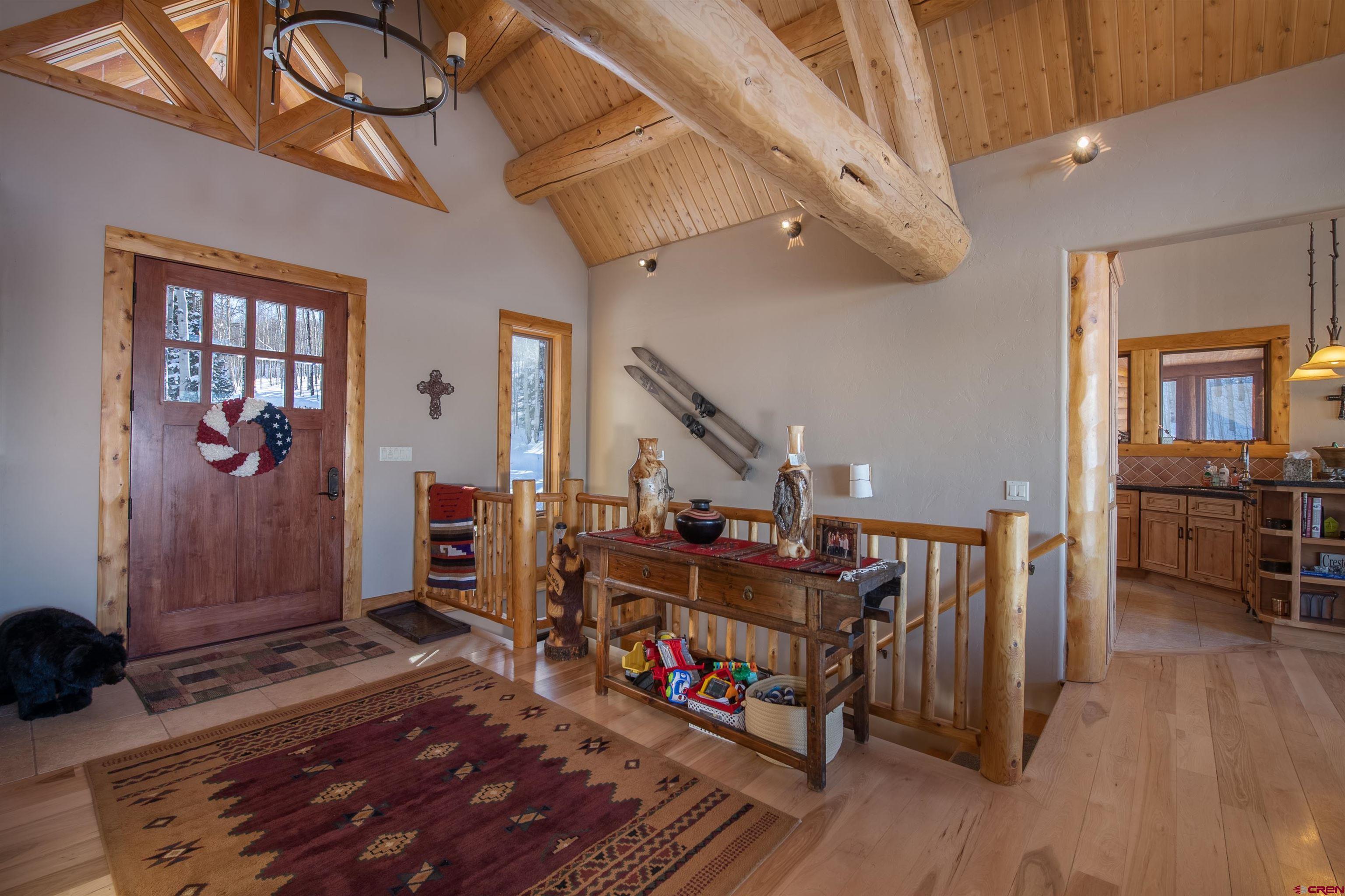 1894 Red Mountain Ranch Road Crested Butte, CO 81224 - Photo 10 of 34 a view of a hallway with wooden floor and stairs