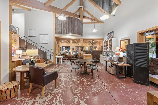 a living room with lots of furniture and a painting on the wall