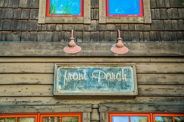 a front view of a house with a yard and trees
