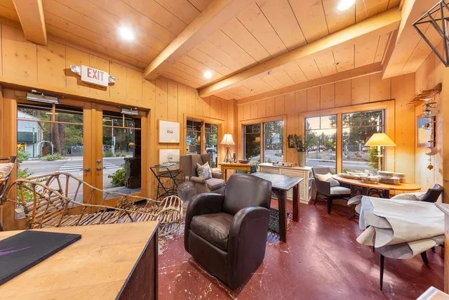 a living room with lots of furniture and a large window