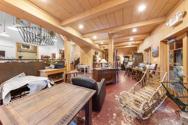 a living room with lots of furniture and view of a chandelier