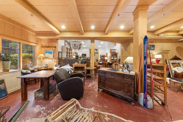 a living room with lots of furniture and a large window