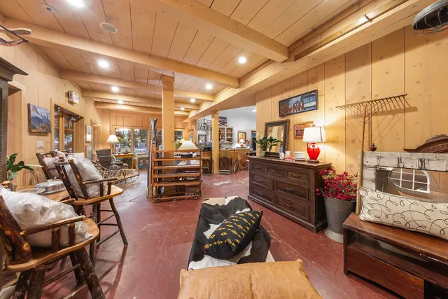 a living room with lots of furniture and kitchen view