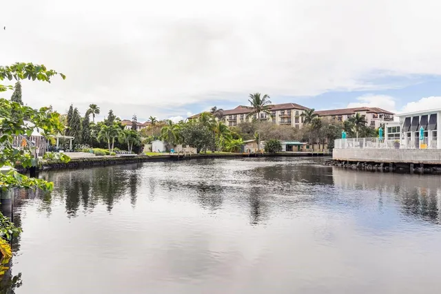 a view of residential house with outdoor space and lake