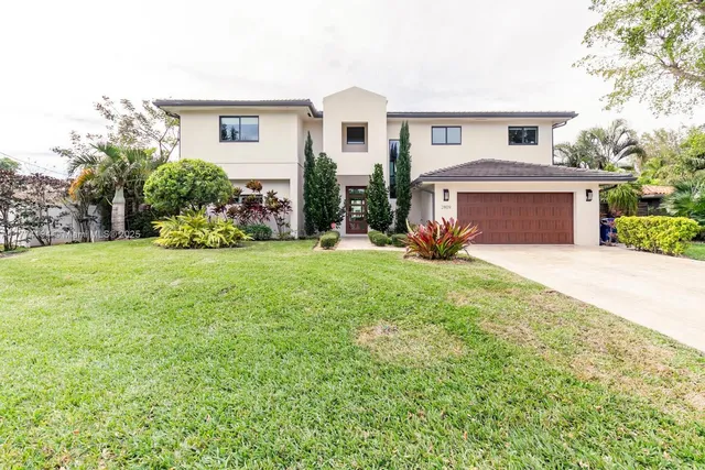 a bathroom with a granite countertop sink a toilet a mirror and bathtub