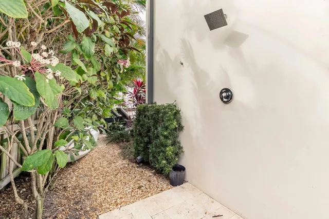 a bathroom with a bathtub a window and a shower