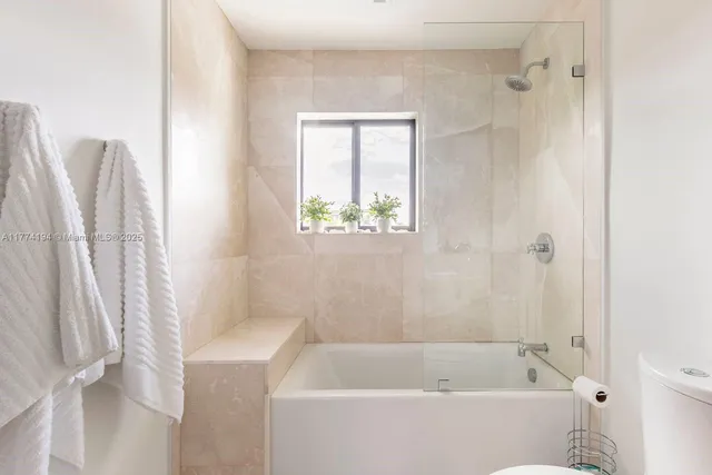 a bathroom with a shower and a toilet