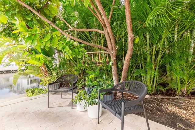 an aerial view of a house with a yard basket ball court and outdoor seating
