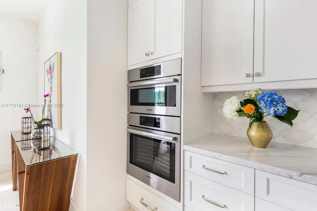 a kitchen with a sink cabinets and appliances